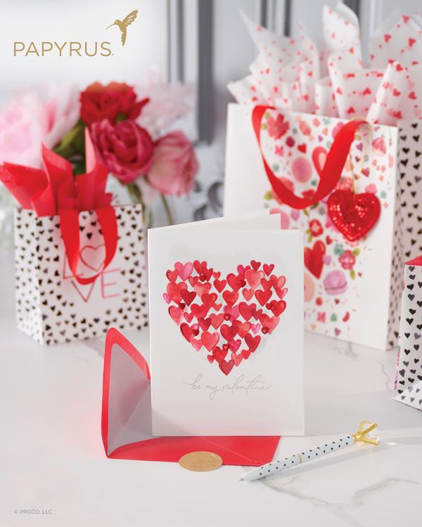 Papyrus Valentine's Day card, envelope, and gift bags on table with diamond pen and roses