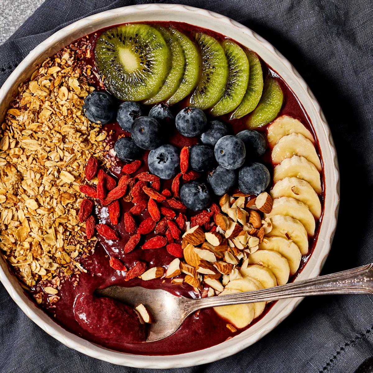 acai breakfast bowl with fresh berries, banana slices and almonds