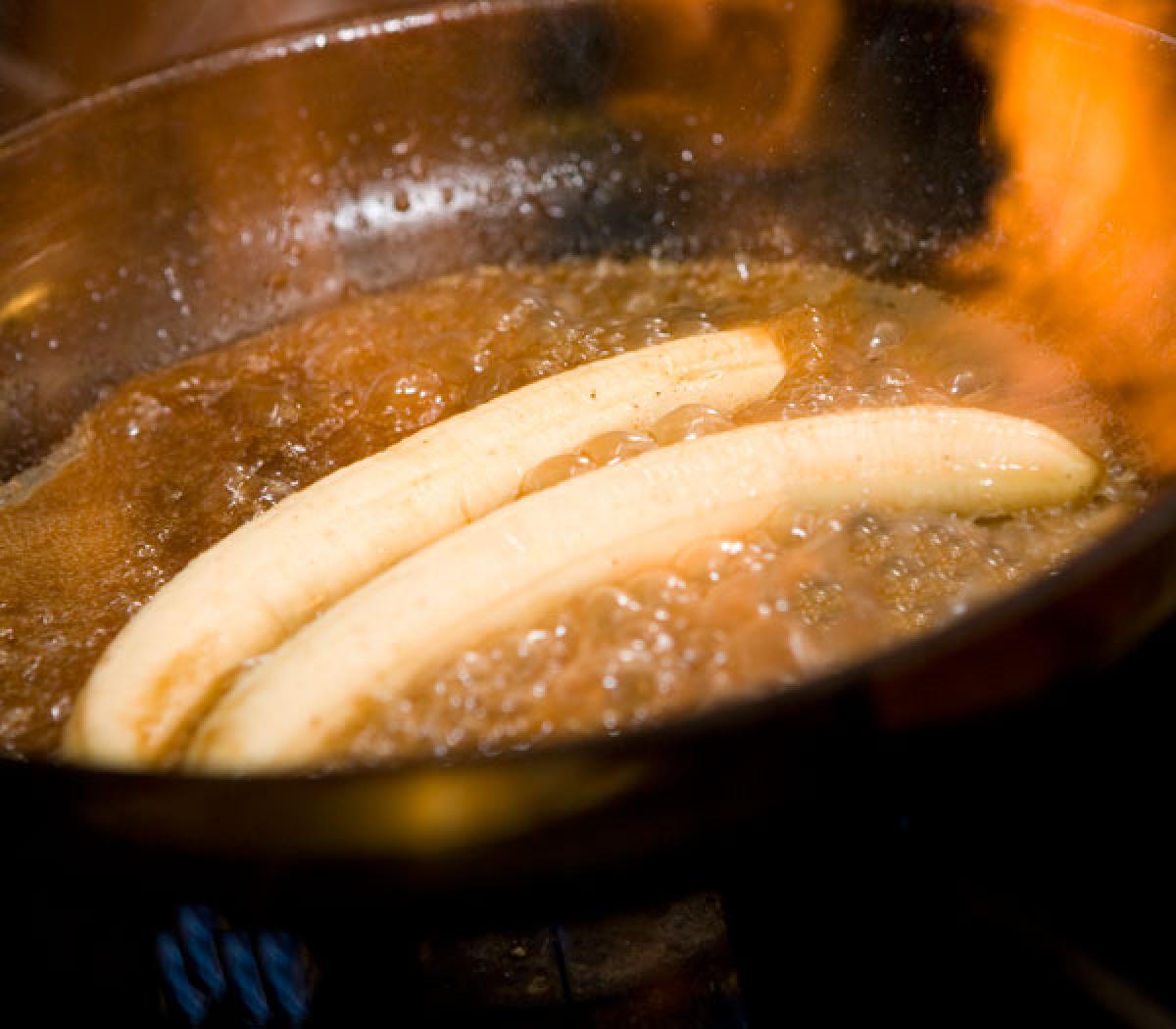Bananas foster in pan with flame
