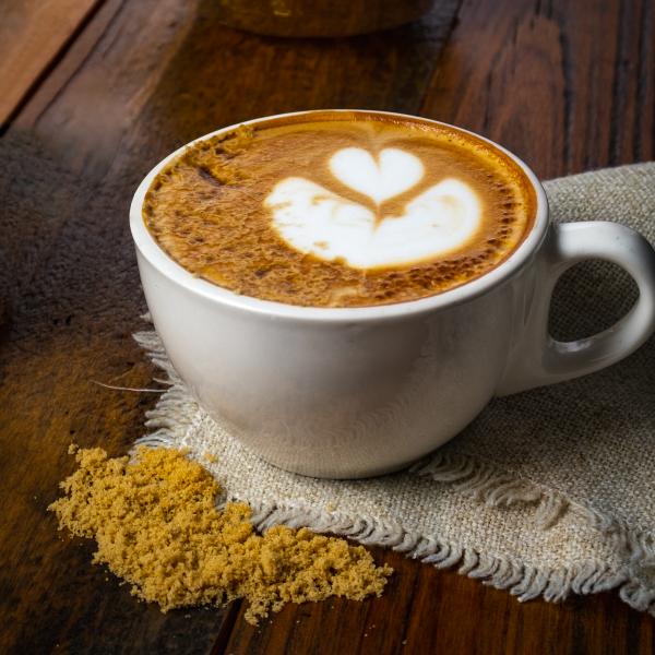 Brown Sugar Maple Latte in ceramic mug on napkin with brown sugar and latte art