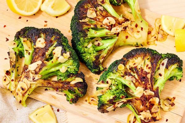 Caramelized broccoli with garlic and lemon wedges