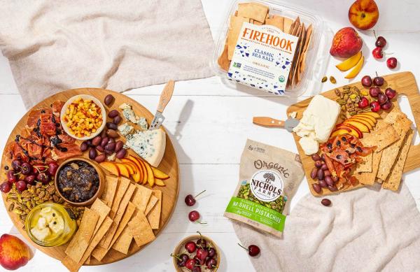 snack spread including DeLallo Olives, Stonewall Kitchen Jams, Meredith Dairy Farmstead Marinated Sheep & Goat Cheese, Firehook Artisan Baked Crackers, and Nichols Farms Pistachios