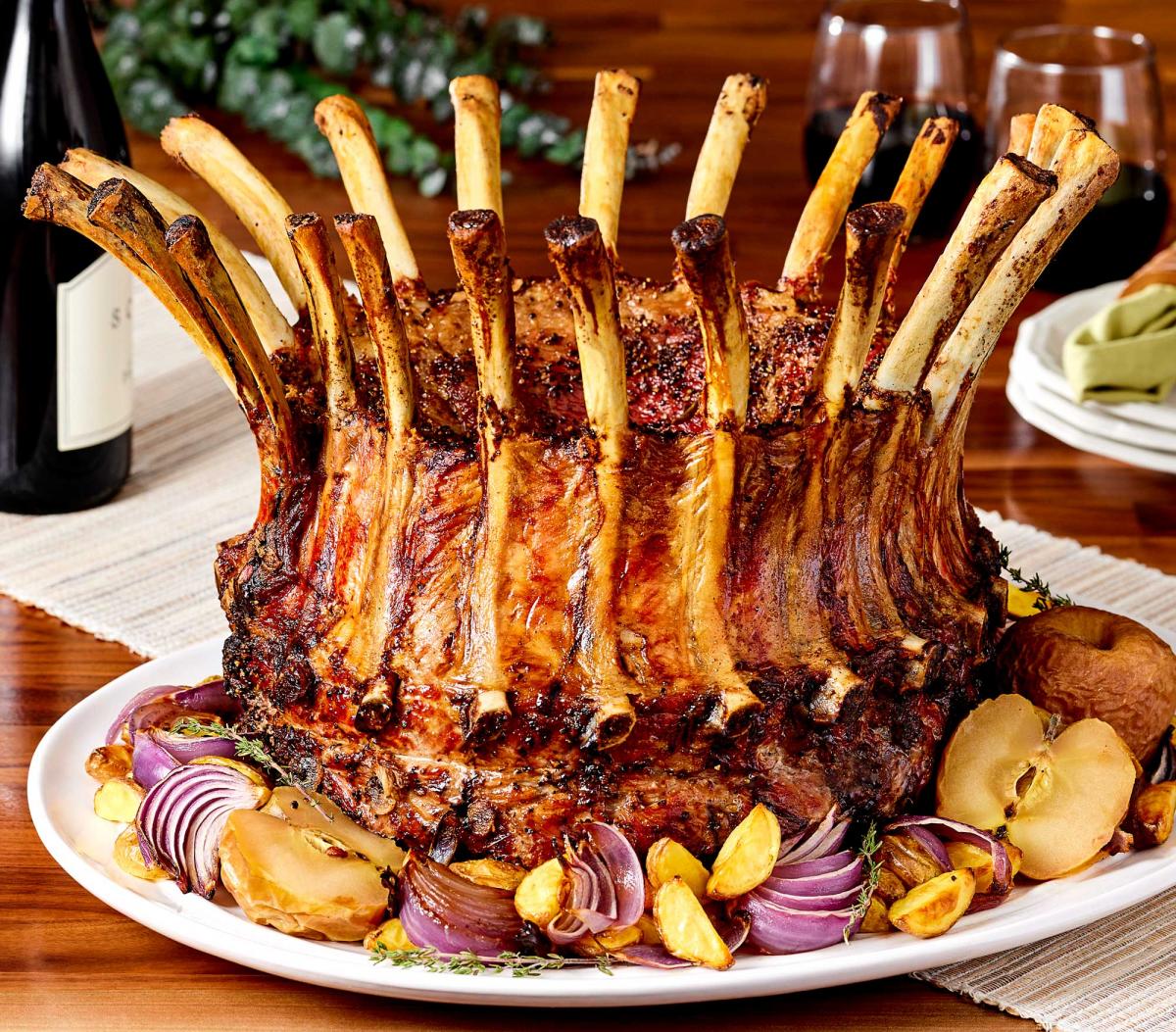 Pork Crown Roast with baked apples, roasted potatos and red onion