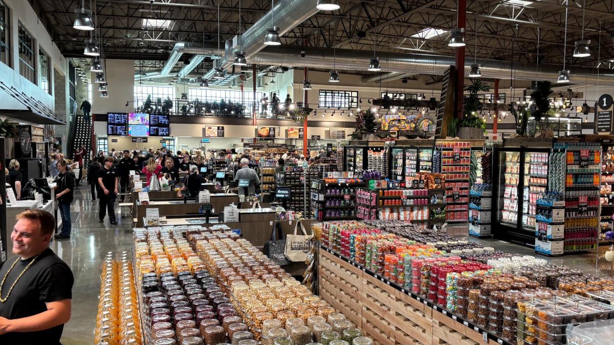 Inside of Nugget Market Rocklin on opening day, showing bulk department, aisles, checkstands, mezzanine, guests, and associates