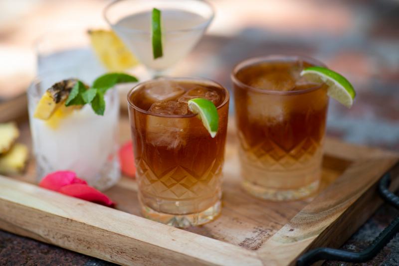 dark and stormy cocktails on a tray, two more in the back of tray