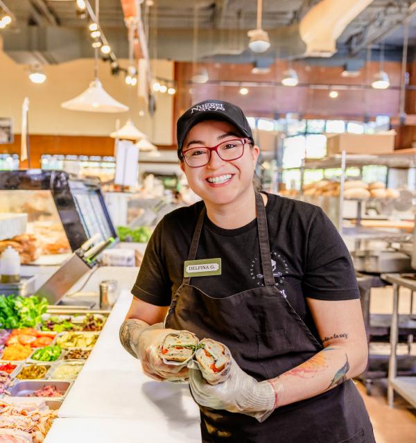 Deli associate with sandwich