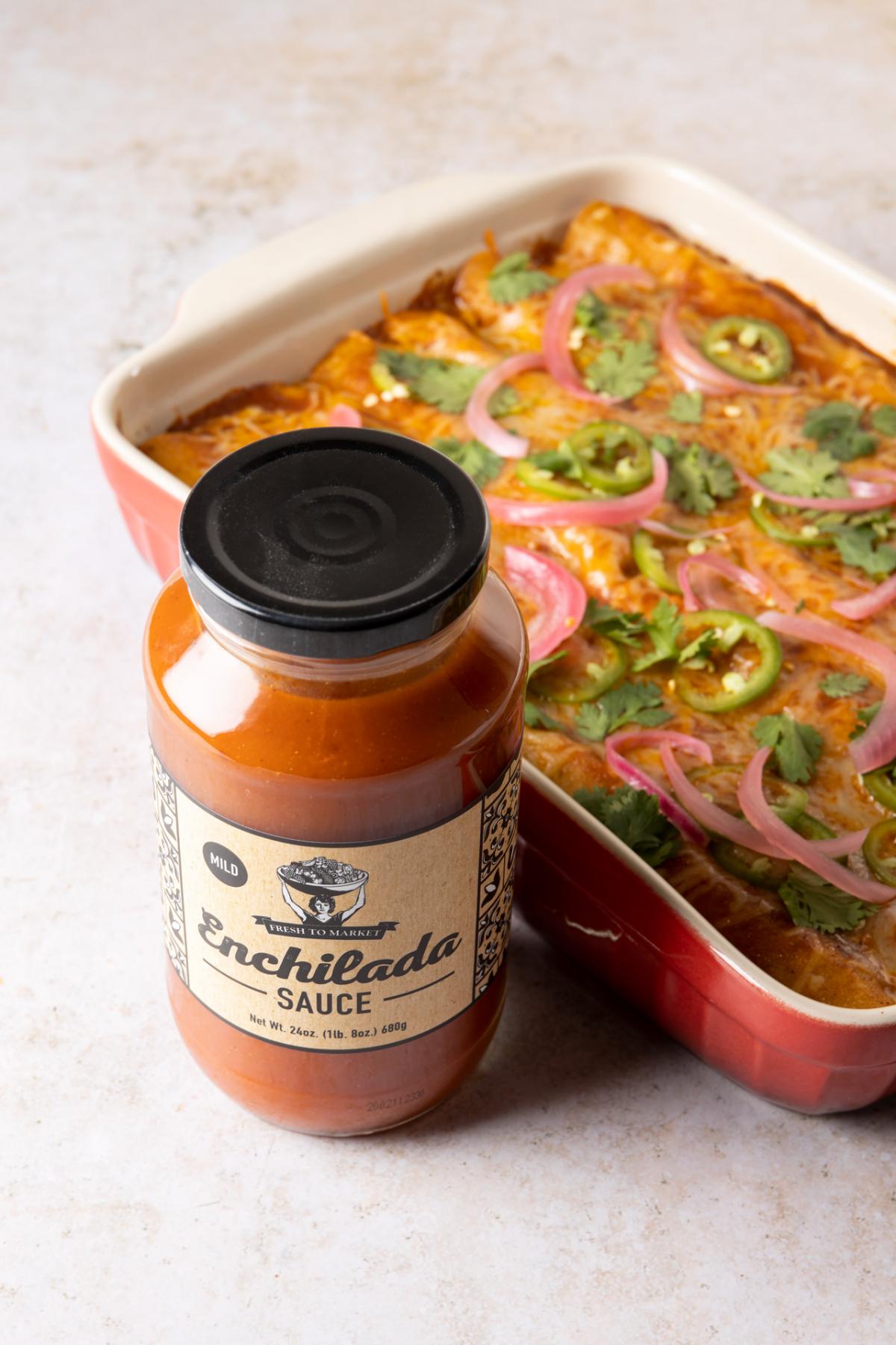 Pan of enchiladas and a jar of enchilada sauce