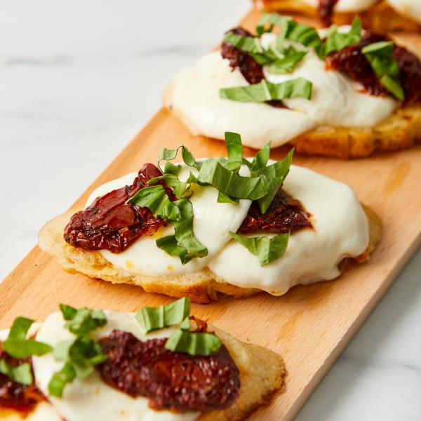 bread slice with cheese, sundried tomato and basil