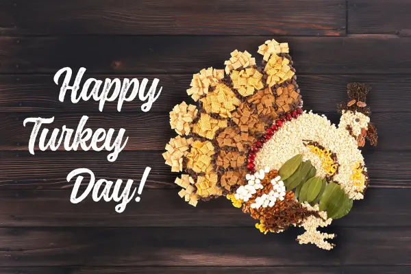 Happy Turkey Day text next to turkey art made with food