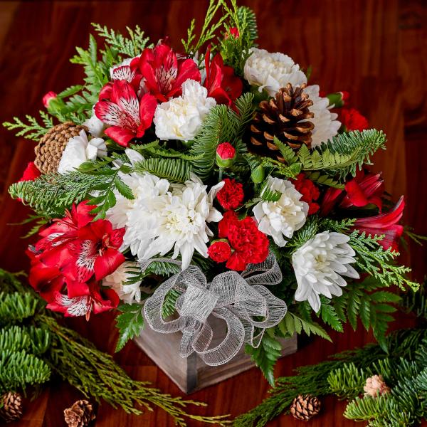Sequoia Holiday Floral Arrangement with Red flowers and pinecones as accents