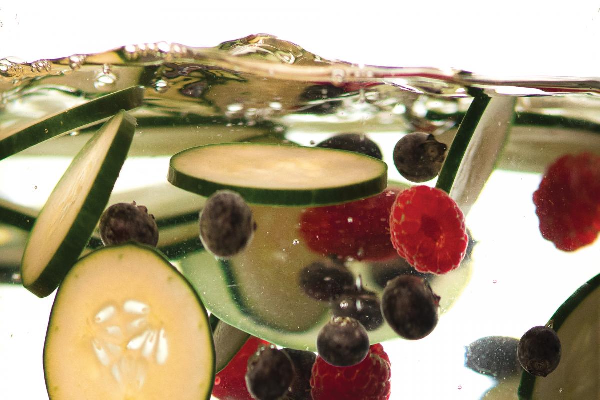 cucumber slices and berries floating in water