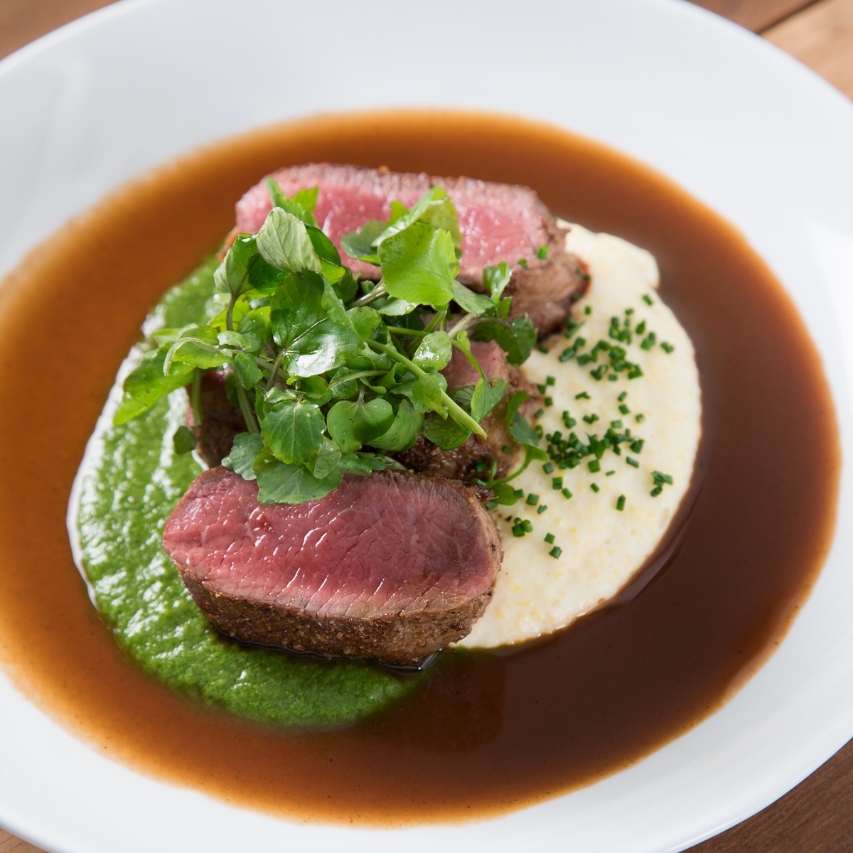 Lamb medallions with watercress puree and polenta