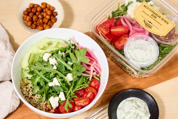 Mediterranean Quinoa Bowl plated and in clear package with chickpeas and tzatziki on the side