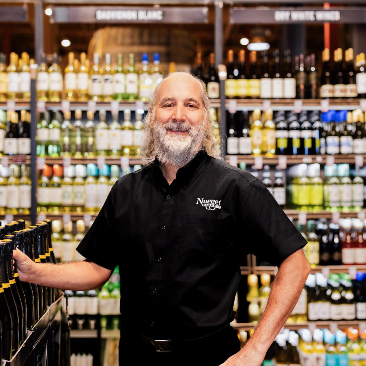 Mike Taylor smiling in Adult Beverage Department of Rocklin Nugget Market