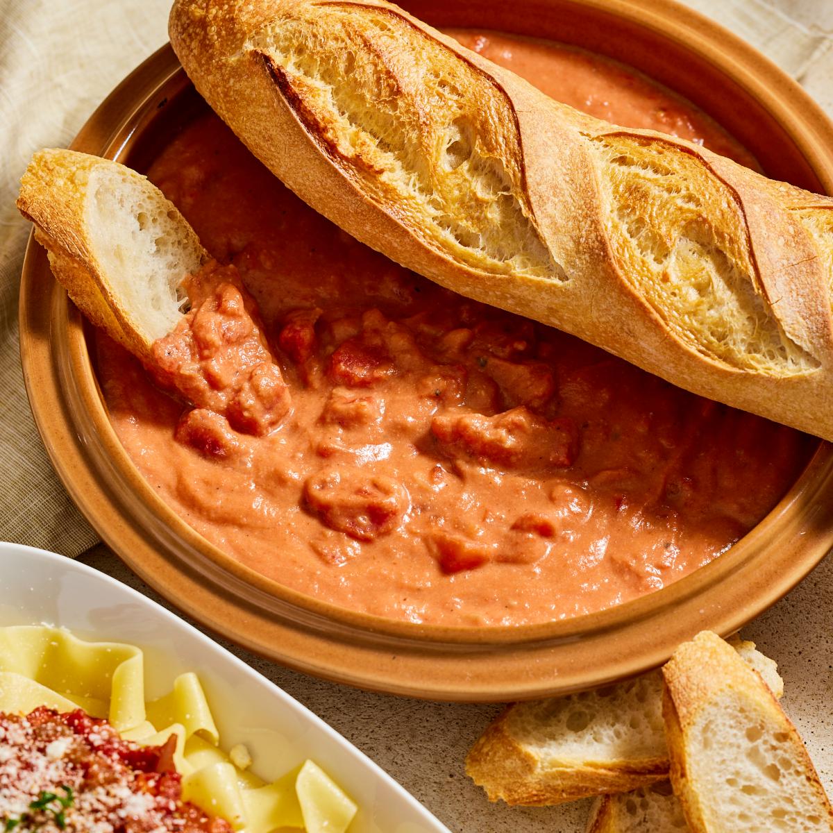 Nan's Tomato Gravy with bagueete bread slices dipping in crock of it