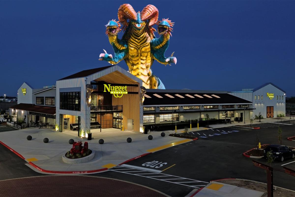 Exterior night shot of the Nugget Markets Rocklin store with a giant multi-headed monster kaiju digitally composited looming over the building