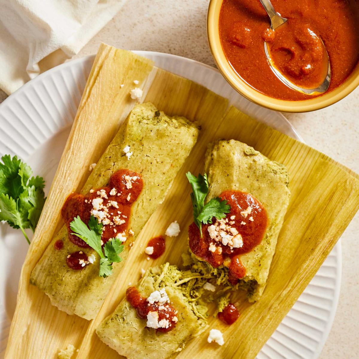 Old Yolo Tamale Parlor Sauce on top of two chicken verde tamales