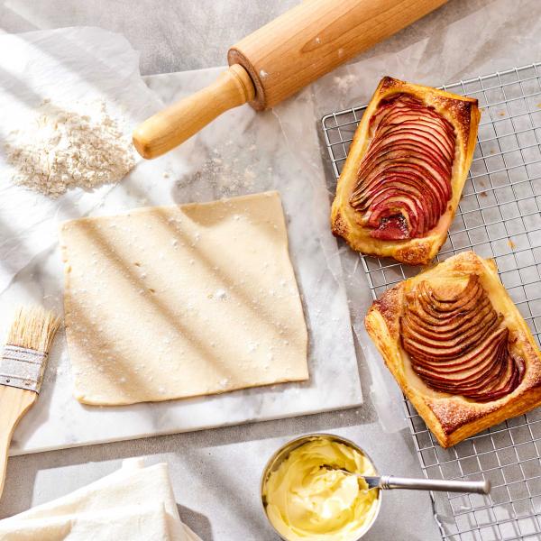 Laminated Dough Base image with puff pastry, butter, rolling pin and finished tarts