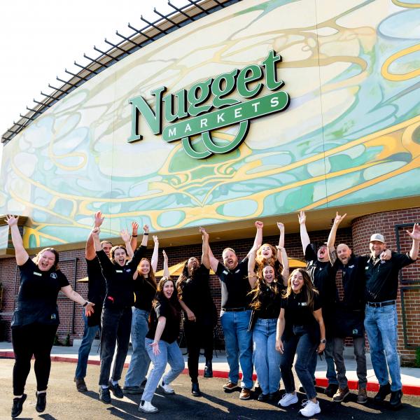 Group of excited associates outside Nugget Market Granite Bay store