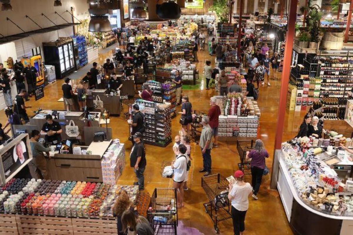 View from Nugget Market Granite Bay mezzanine showing guests in line at check stands plus cheese department, displays, and more